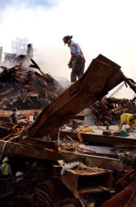 fireman standing on wreckage of 9/11