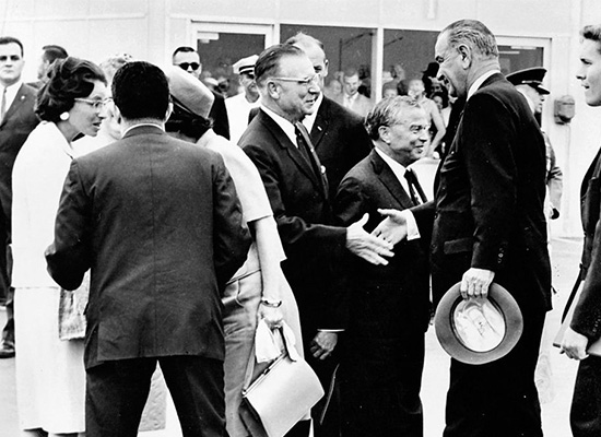 Chancellor Tolley shaking hands with President Johnson at Hancock International Airport