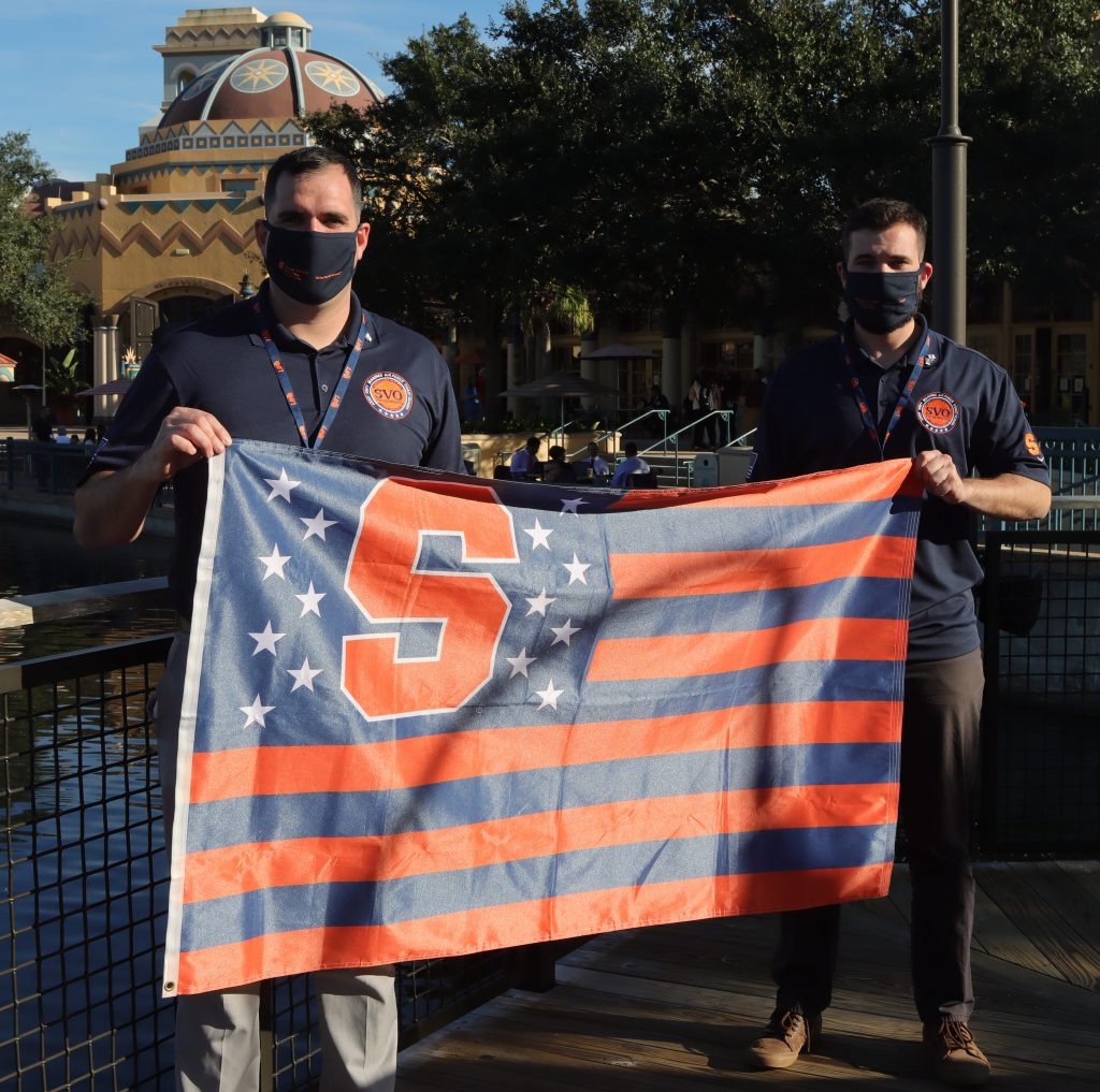 Adrian Bryne holding orange SU flag