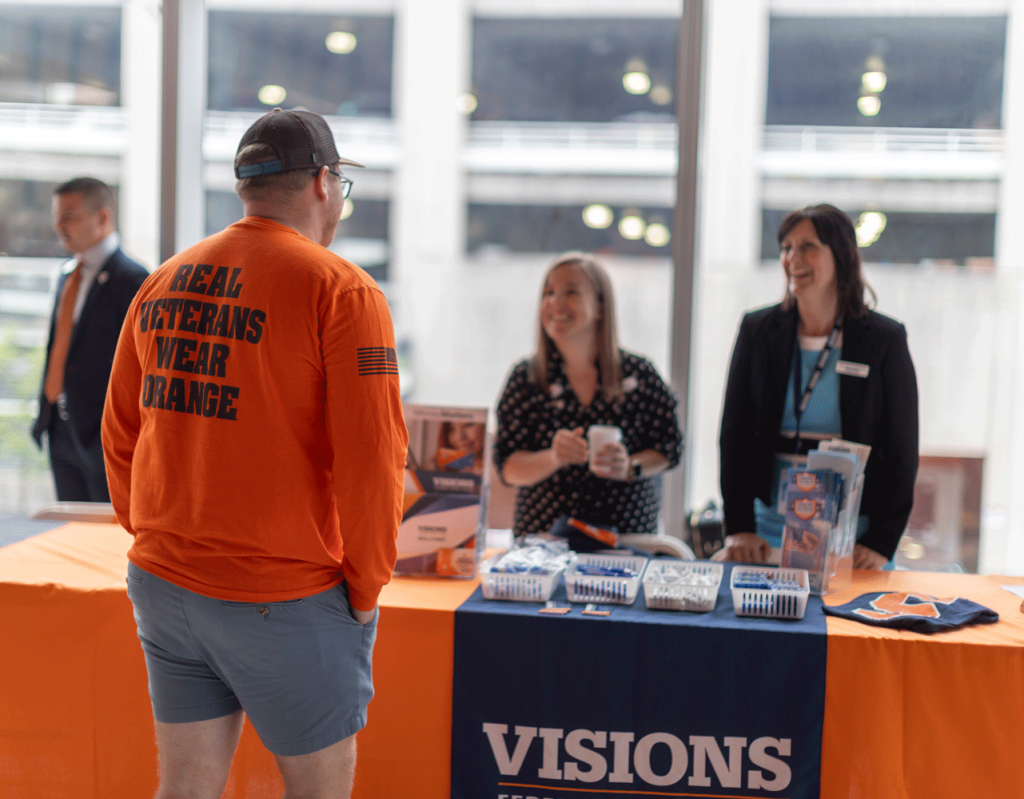 Visions federal credit union representative talking to student veteran