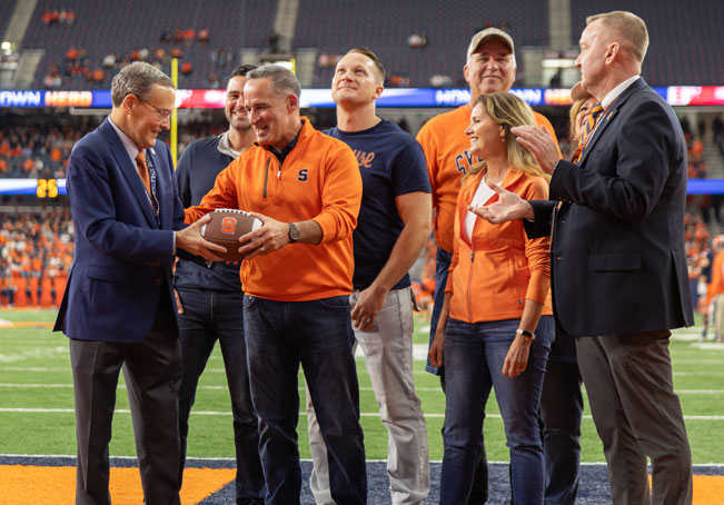 Hth mike Frasciello on dome field surrounded by family.