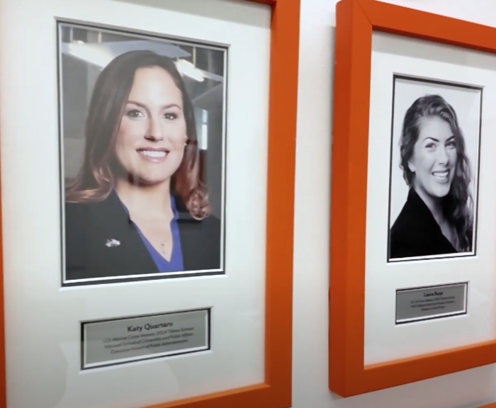 Tillman scholars in picture frames hanging on a wall.