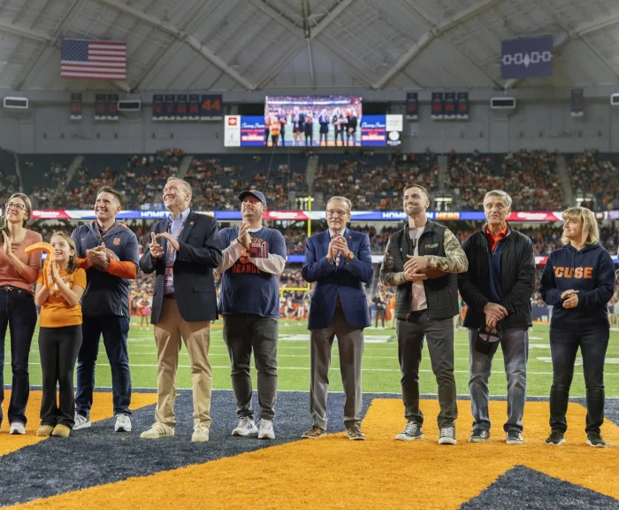Group photo on dome field for hometown Hero