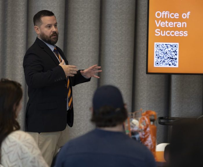 Justin Machian speaking in front of students.