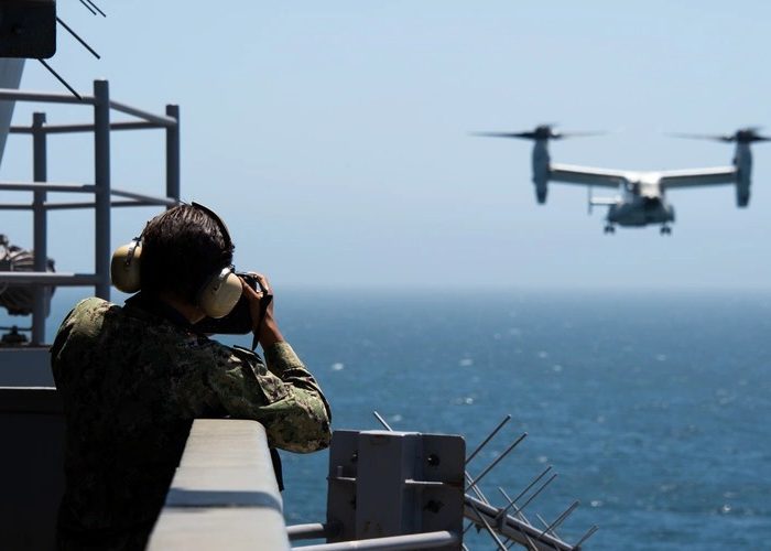 analice Baker taking photo of incoming air craft