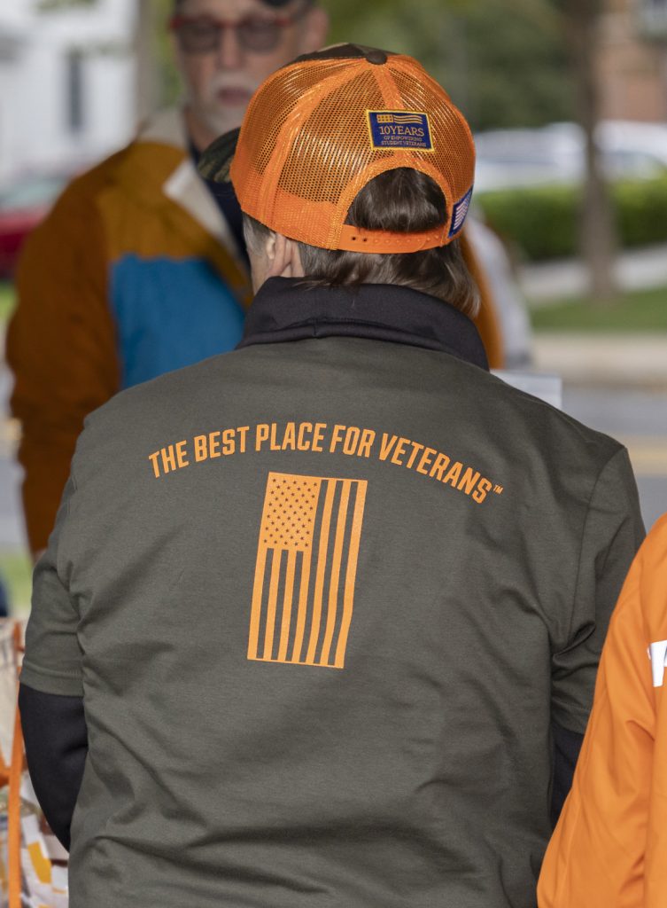 Tshirt that says best place for veterans on it with an orange flag.