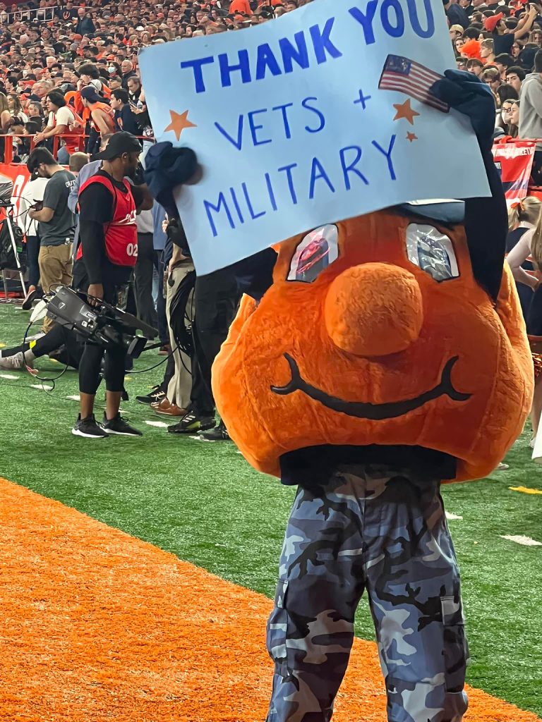Otto holding sign at football game in Dome.