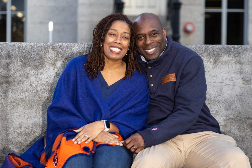 Allison and Dwayne murray on SU campus kissing bench.