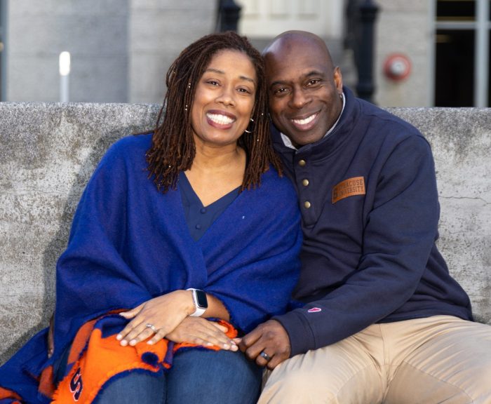 Allison and Dwayne murray on SU campus kissing bench.