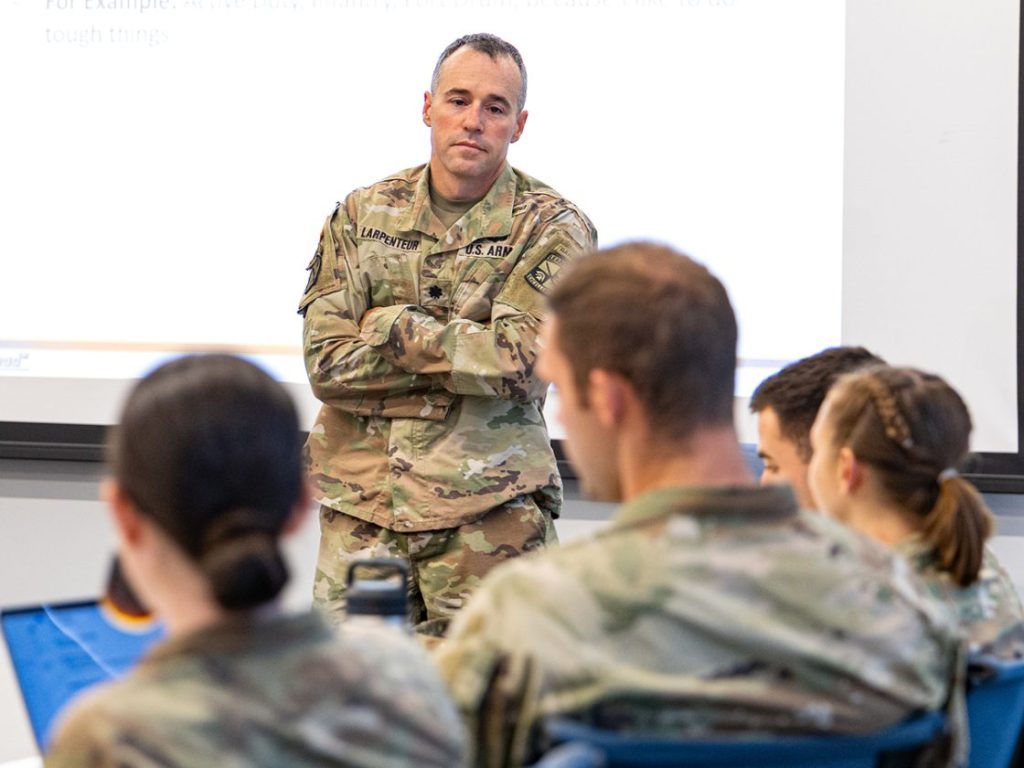 Lt.Col. Larpenteur teaching at front of classroom