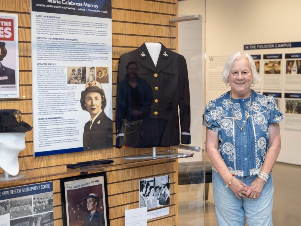 Maria Murray standing in front of her mother's exhibit in nvrc