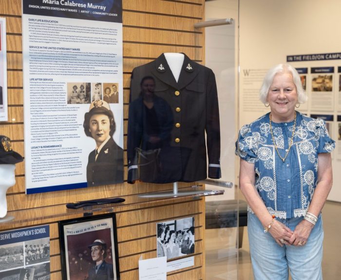 Maria Murray standing in front of her mother's exhibit in nvrc