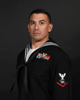 Joshua Carabajal in the navy uniform posing for his official portrait.